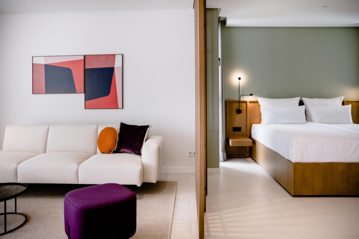 una habitación de hotel con una cama y un sofá en THE FLAG HOTEL Marbella, Estepona Adult Recommended, en Estepona