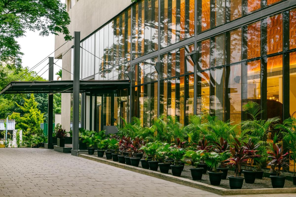 a building with plants in front of it at Greenpark Bengaluru in Bengaluru a building with plants in front of it at Greenpark Bengaluru in Bengaluru