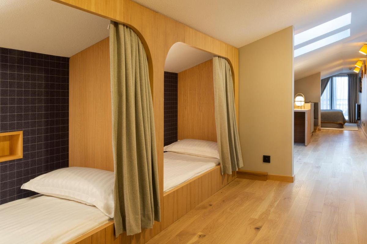 Un ou plusieurs lits dans un hébergement de l'établissement Heliopic Hotel & Spa