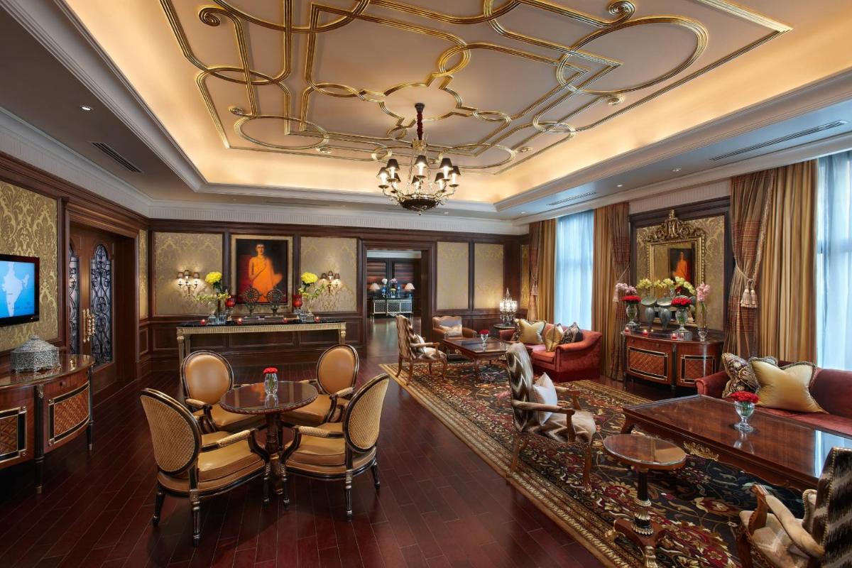 a living room filled with furniture and a chandelier at The Leela Palace New Delhi in New Delhi a living room filled with furniture and a chandelier at The Leela Palace New Delhi in New Delhi