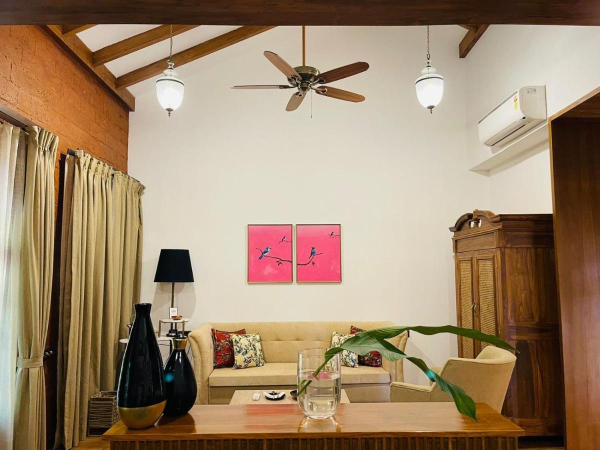 a living room with a couch and a ceiling fan at The Postcard Saligao in Calangute