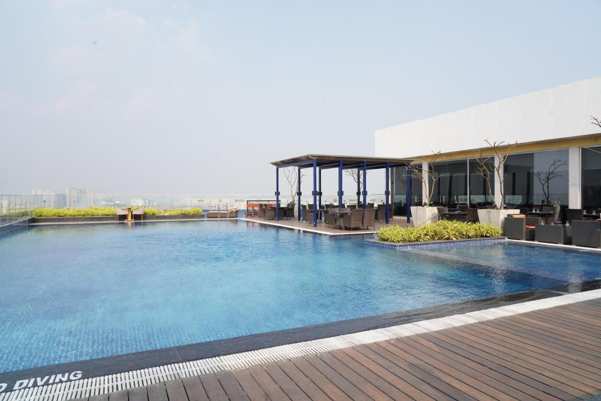 a large swimming pool on top of a building at Marriott Executive Apartments Hyderabad in Hyderabad