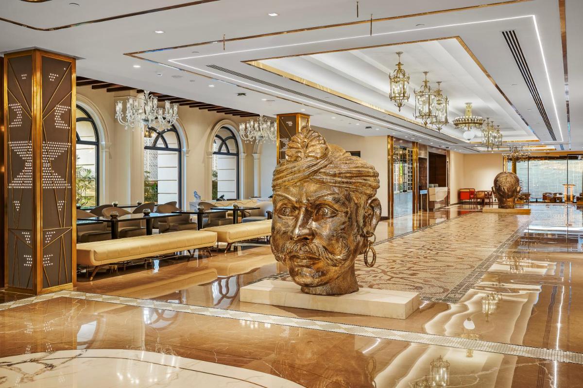 a statue of a face in a lobby at Radisson Blu Hotel & Suites GRT Chennai in Chennai