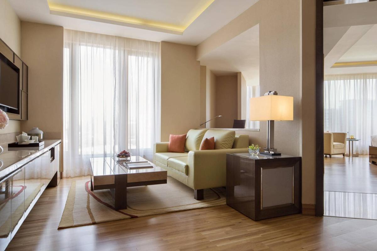 a living room with a couch and a table at JW Marriott Mumbai Sahar Airport in Mumbai a living room with a couch and a table at JW Marriott Mumbai Sahar Airport in Mumbai