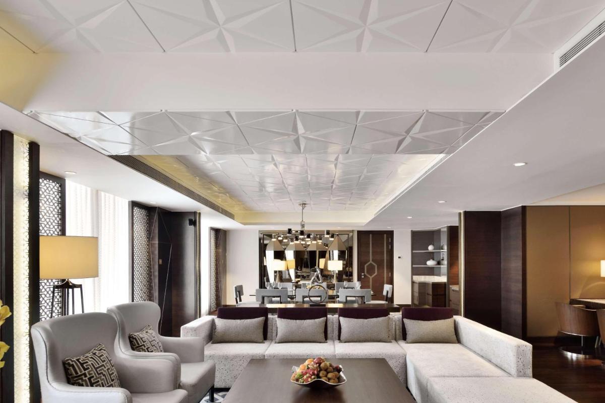 a living room with a couch and a table at JW Marriott Mumbai Sahar Airport in Mumbai a living room with a couch and a table at JW Marriott Mumbai Sahar Airport in Mumbai