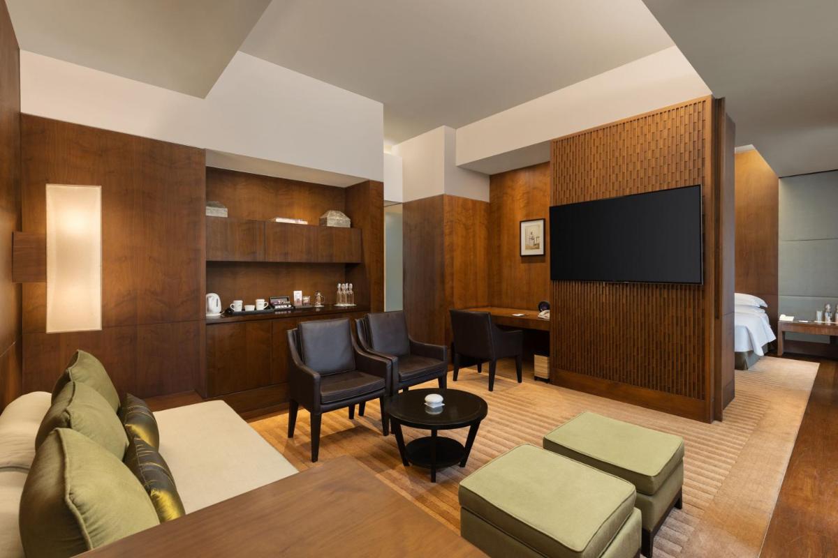 a hotel room with a couch and a television at ITC Sonar, a Luxury Collection Hotel, Kolkata in Kolkata