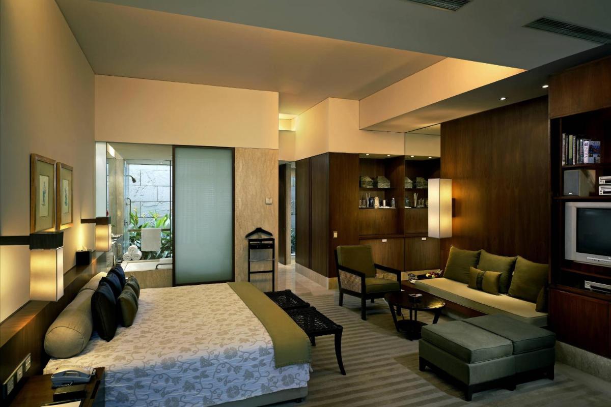 a bedroom with a bed and a living room at ITC Sonar, a Luxury Collection Hotel, Kolkata in Kolkata
