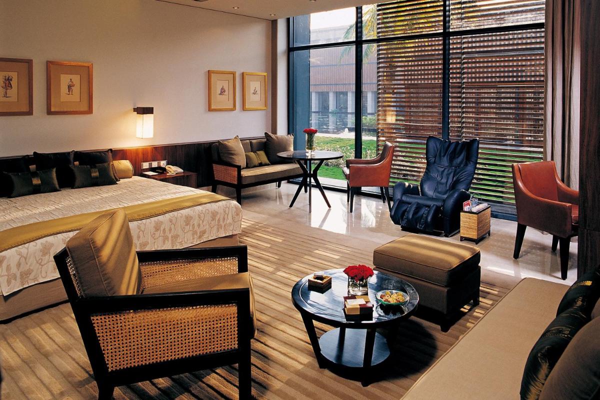 a hotel room with a bed and a living room at ITC Sonar, a Luxury Collection Hotel, Kolkata in Kolkata
