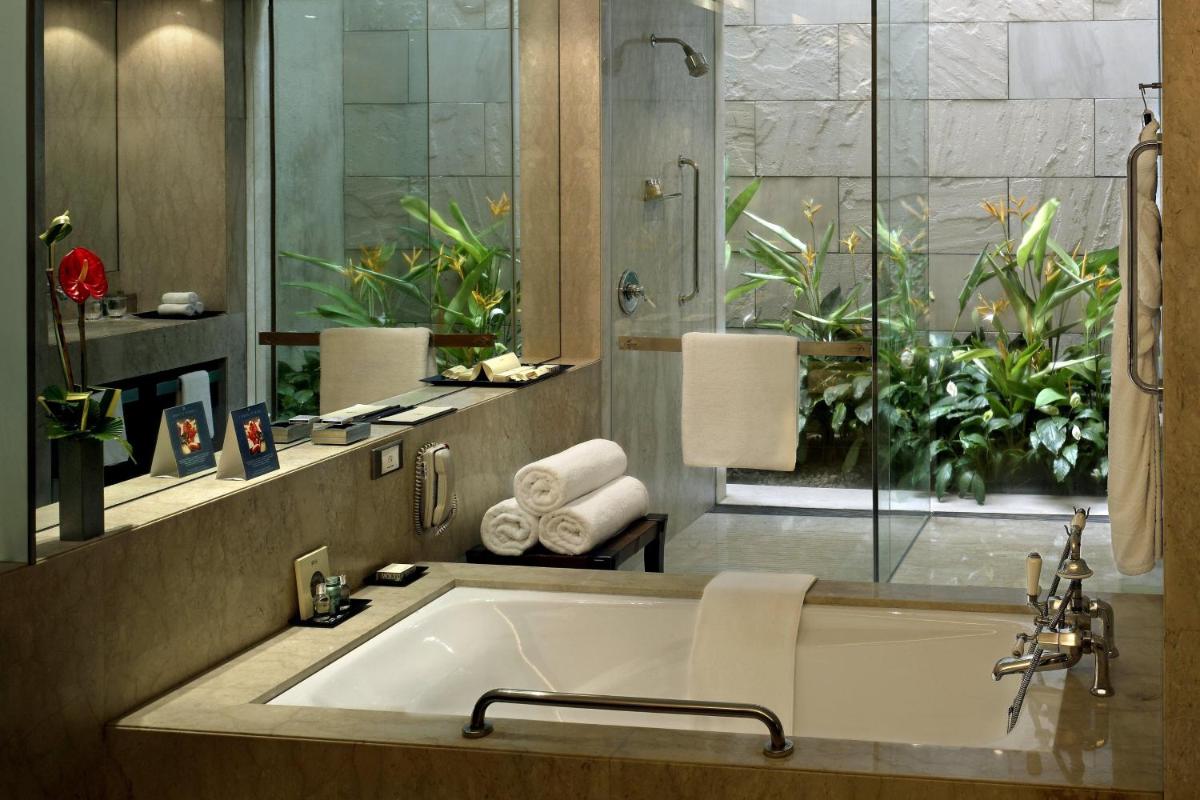 a bathroom with a large bath tub with a window at ITC Sonar, a Luxury Collection Hotel, Kolkata in Kolkata