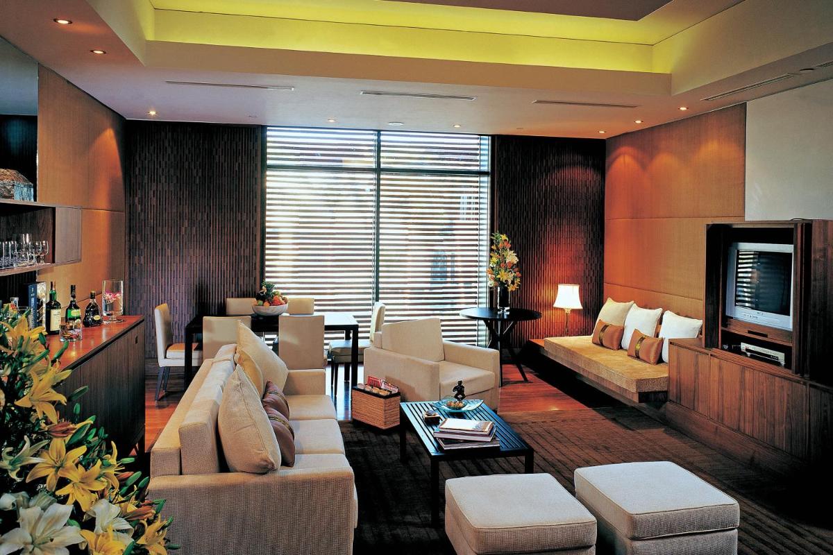 a living room with white couches and a television at ITC Sonar, a Luxury Collection Hotel, Kolkata in Kolkata