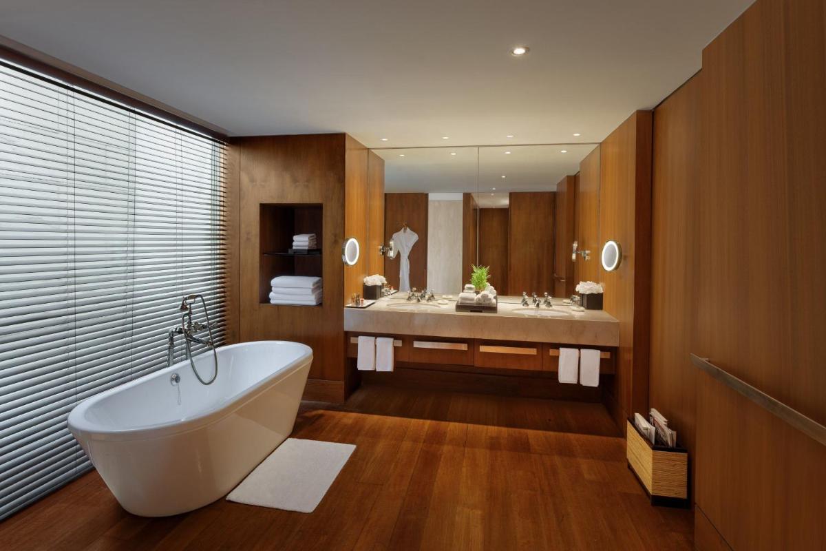 a bathroom with a tub and two sinks in it at ITC Sonar, a Luxury Collection Hotel, Kolkata in Kolkata