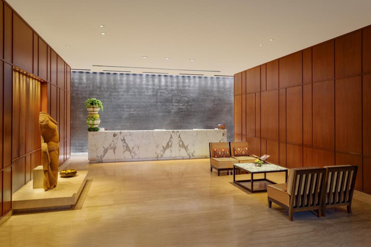 a lobby with a statue of a man and a table at ITC Sonar, a Luxury Collection Hotel, Kolkata in Kolkata