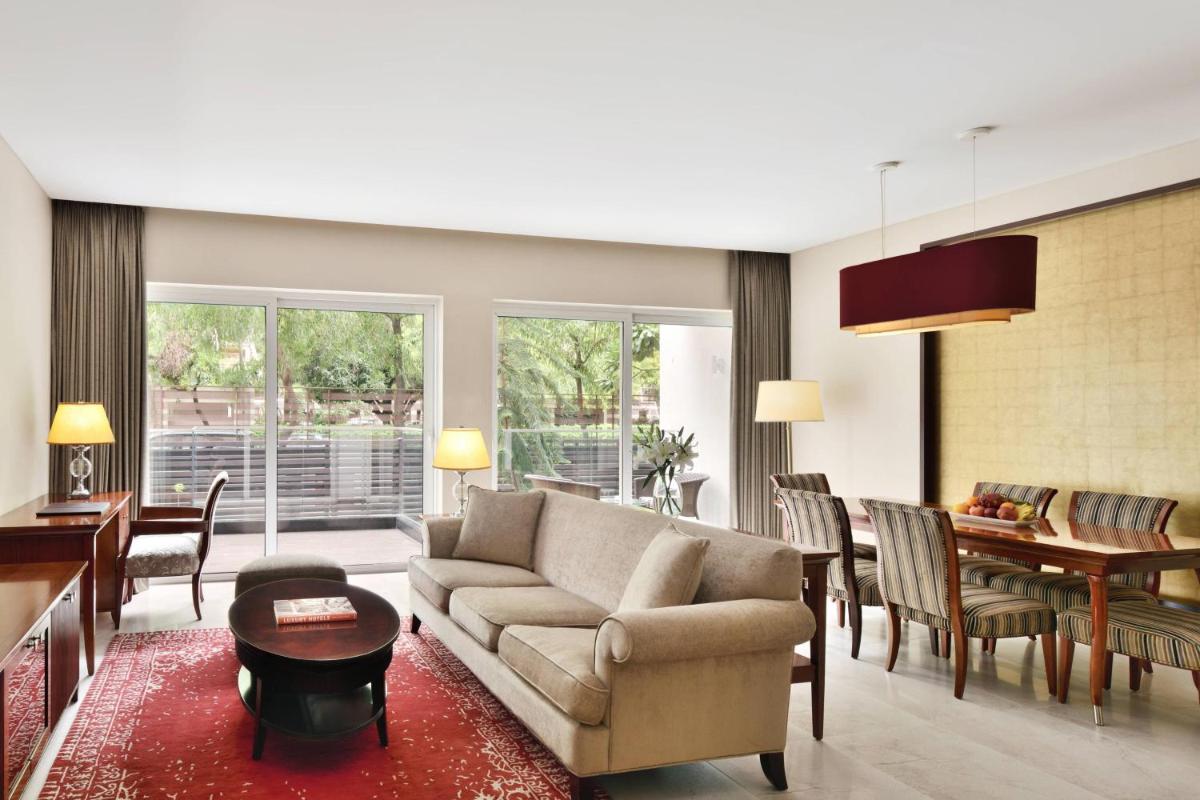 a living room with a couch and a dining room at Marriott Suites Pune in Pune