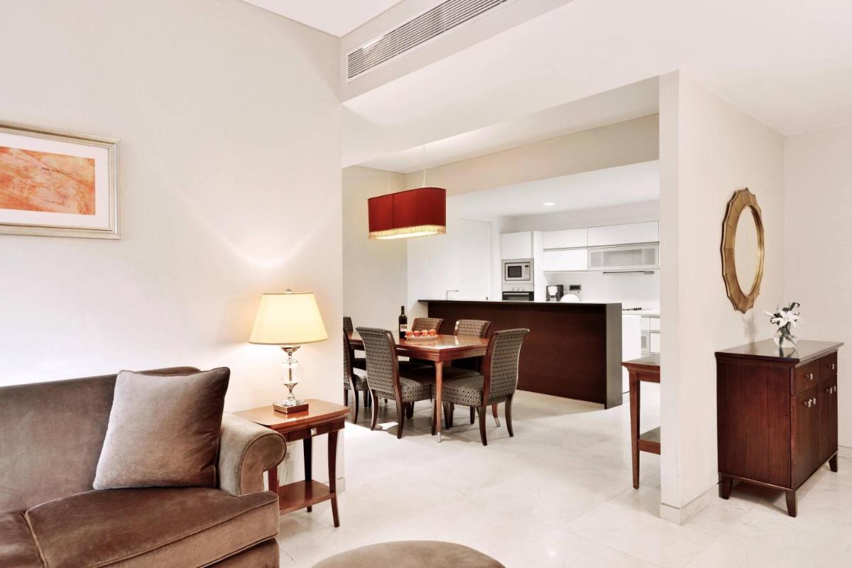 a living room with a couch and a table at Marriott Suites Pune in Pune