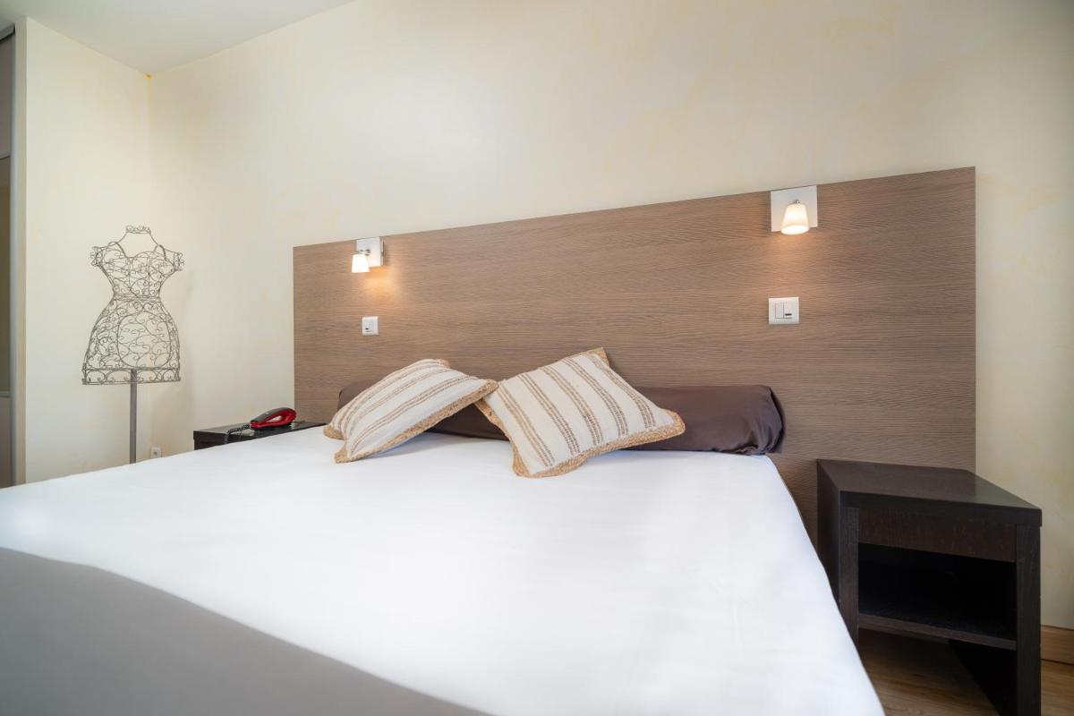 Un ou plusieurs lits dans un hébergement de l'établissement Hôtel Beau Soleil