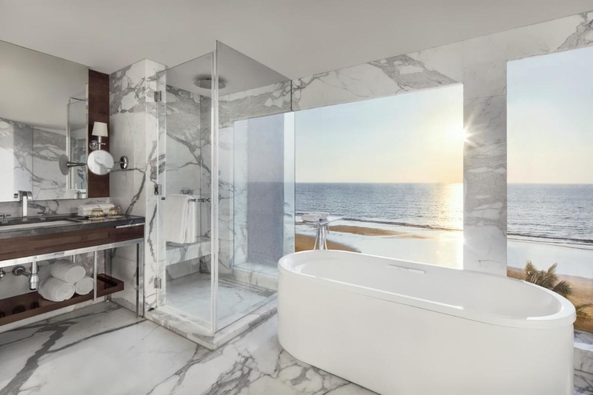 a bathroom with a tub and a view of the ocean at JW Marriott Mumbai Juhu in Mumbai