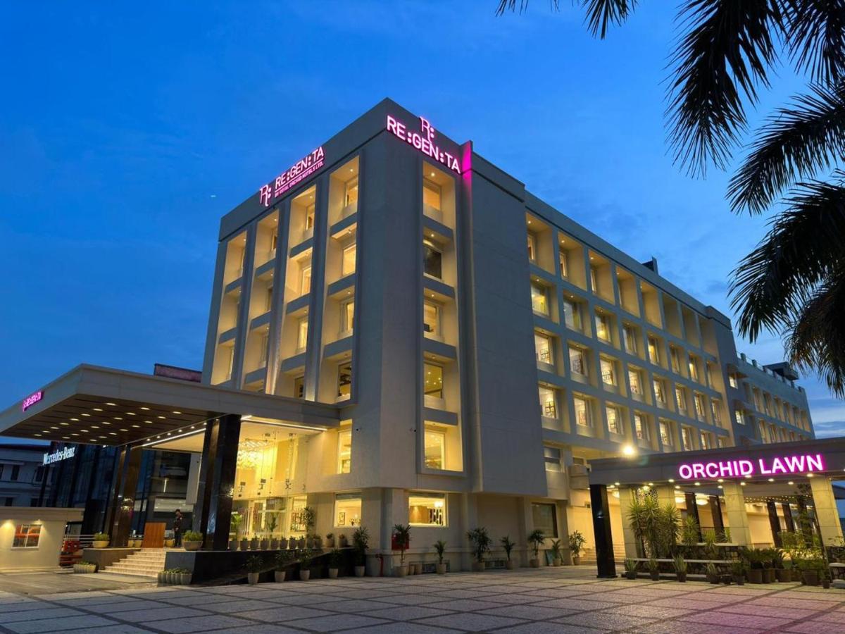 a hotel building with a lit up facade at night at Regenta Dehradun by Royal Orchid Hotels Limited in Dehradun