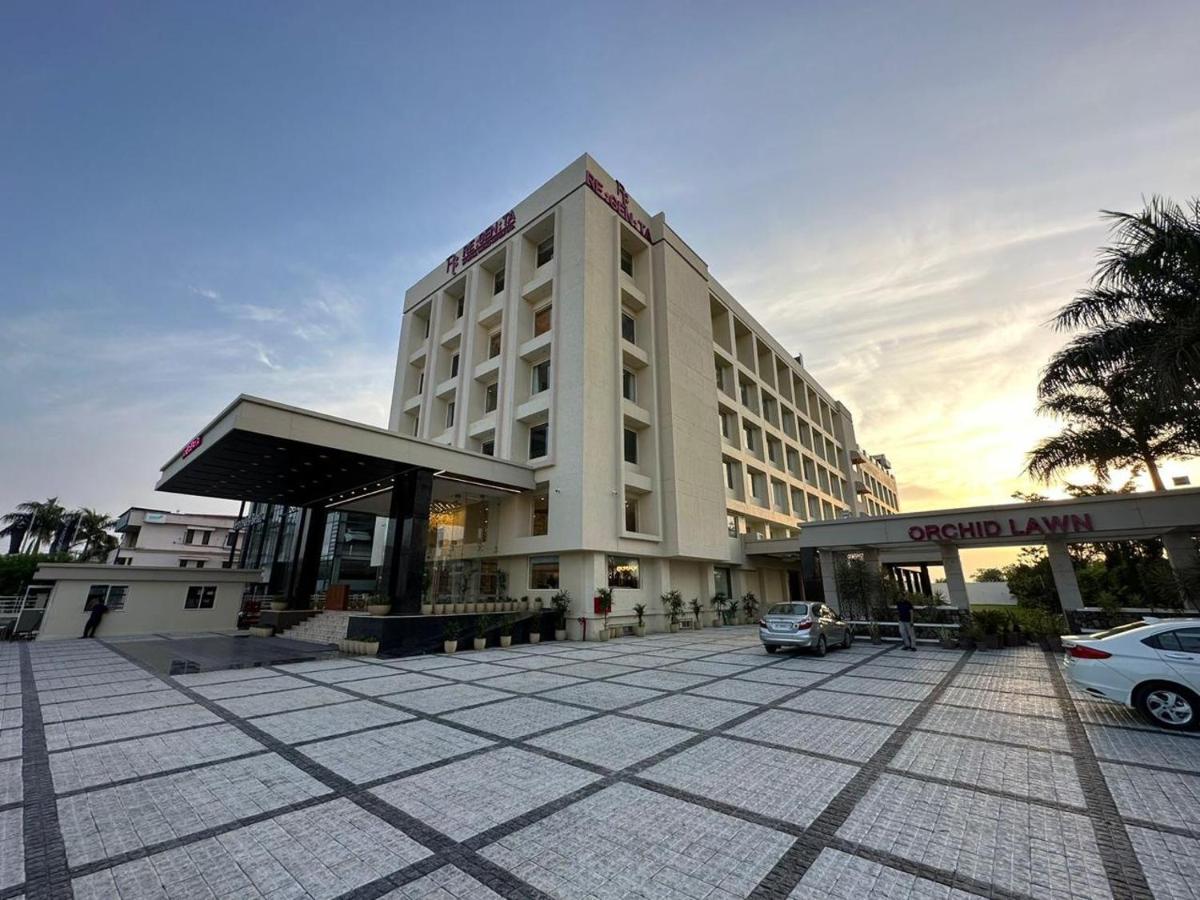 a large building with a car parked in front of it at Regenta Dehradun by Royal Orchid Hotels Limited in Dehradun