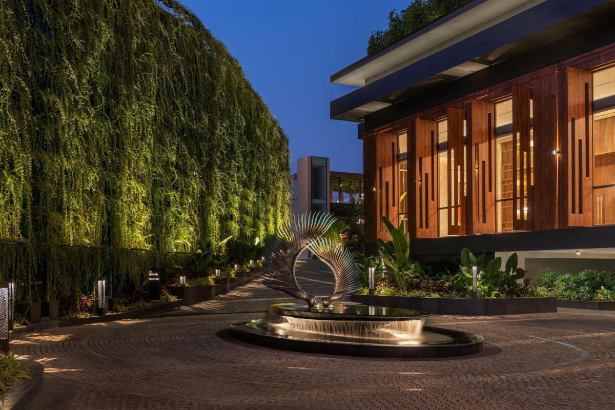 a fountain in a courtyard in front of a building at JW Marriott Goa in Vagator a fountain in a courtyard in front of a building at JW Marriott Goa in Vagator
