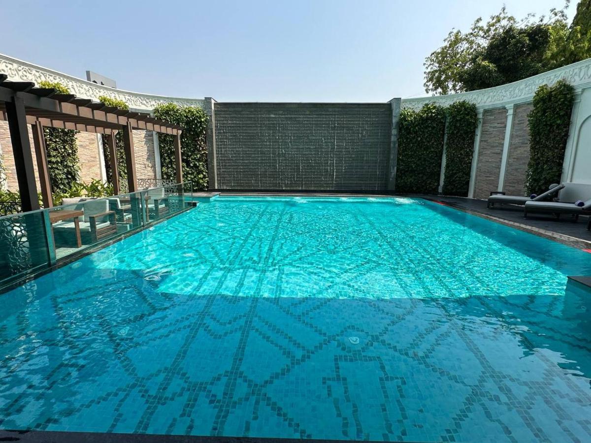 a large swimming pool with blue water at Radisson Blu Hotel & Suites GRT Chennai in Chennai