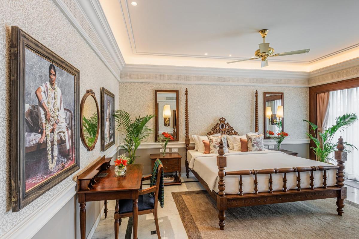 a bedroom with a bed and a table and a desk at Raajkutir - IHCL SeleQtions in Kolkata