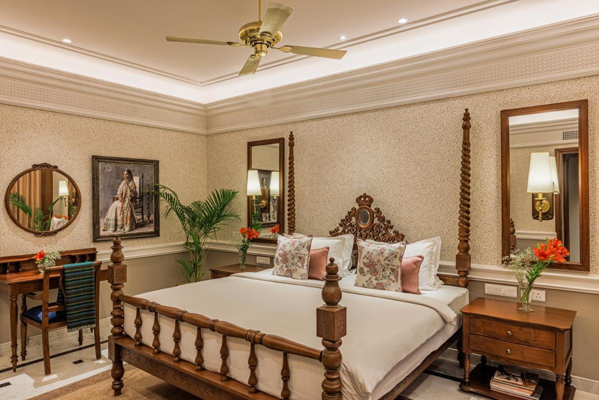 a bedroom with a bed and a ceiling fan at Raajkutir - IHCL SeleQtions in Kolkata