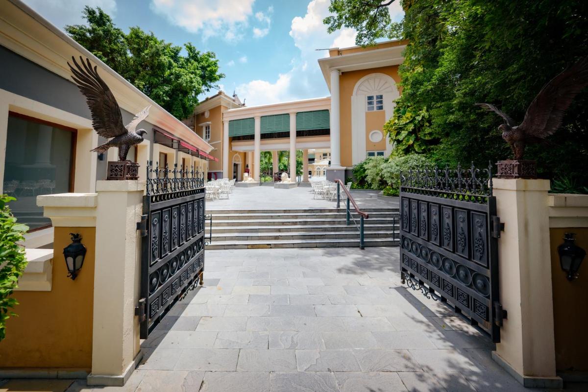 a building with a gate with an eagle statue on it at Raajkutir - IHCL SeleQtions in Kolkata