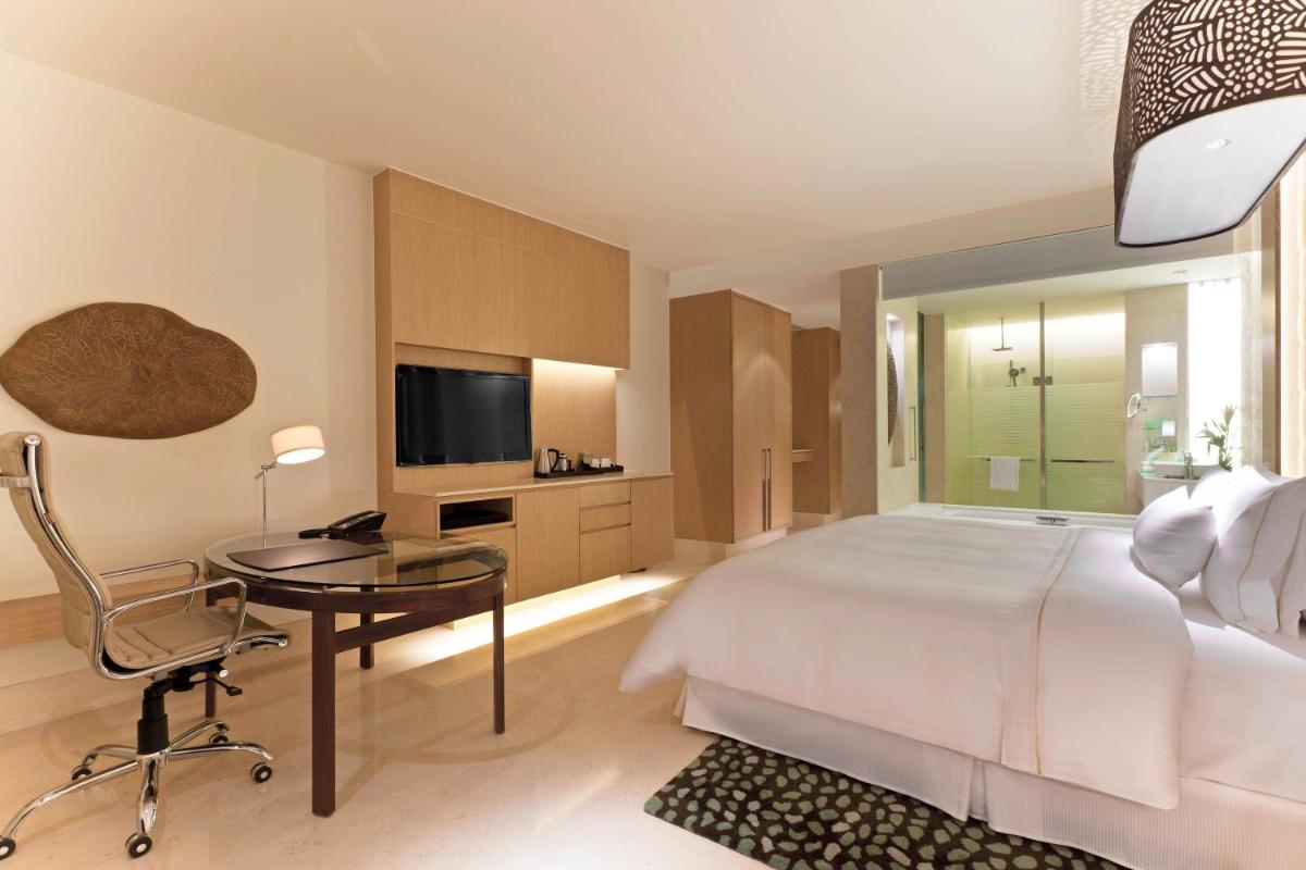 a bedroom with a bed and a desk and a television at The Westin Gurgaon, New Delhi in Gurgaon