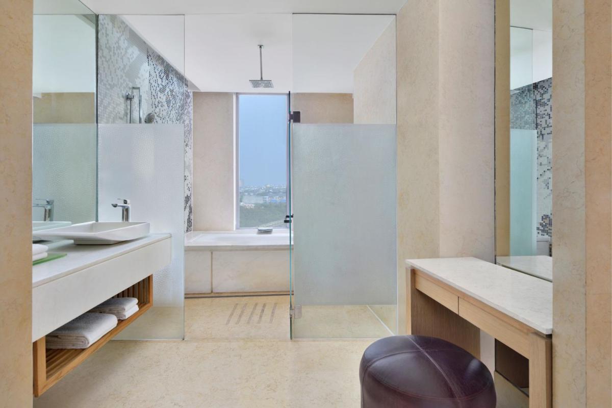 a bathroom with a tub and a sink and a shower at The Westin Gurgaon, New Delhi in Gurgaon
