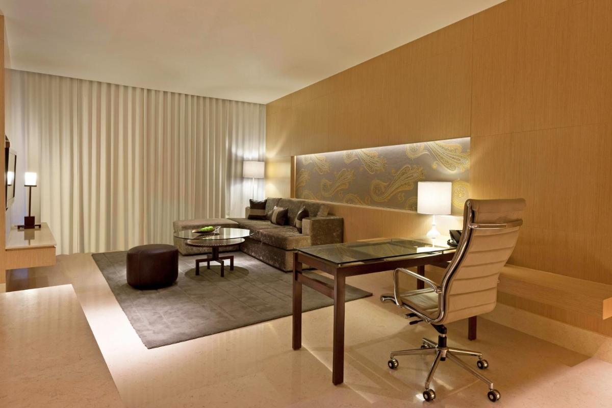 a living room with a desk and a couch at The Westin Gurgaon, New Delhi in Gurgaon