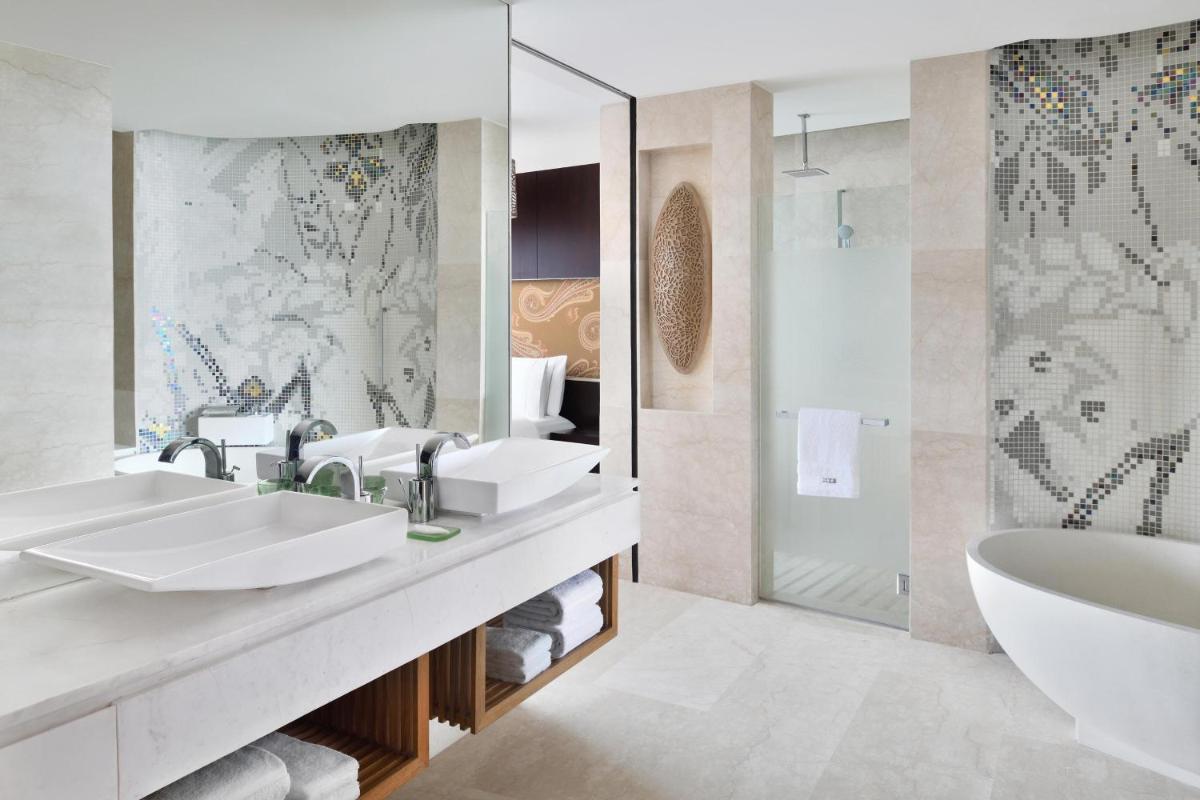 a bathroom with two sinks and a tub and a shower at The Westin Gurgaon, New Delhi in Gurgaon