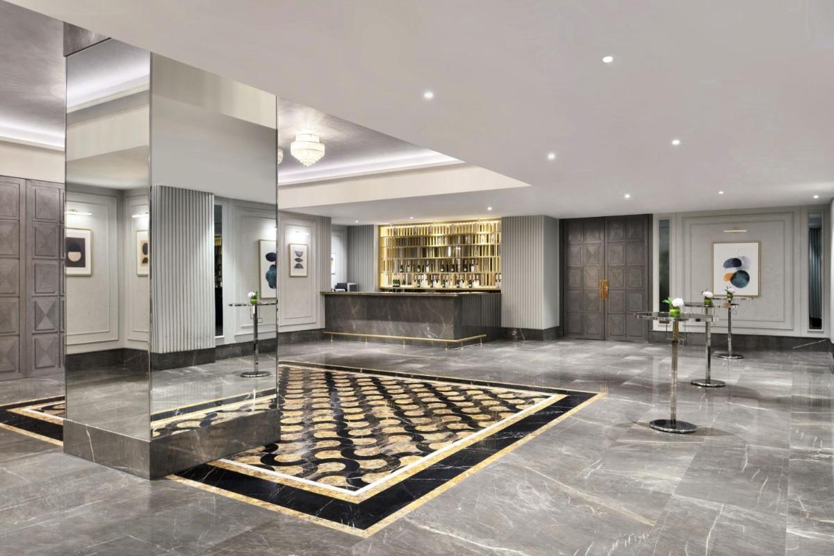 a lobby with a table in the middle of a building at The St. Regis Mumbai in Mumbai