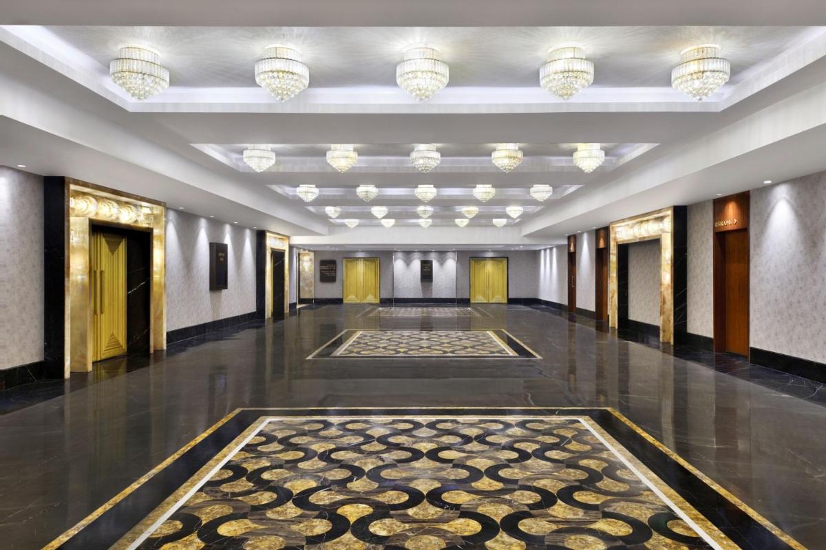 a hallway of a building with a rug on the floor at The St. Regis Mumbai in Mumbai