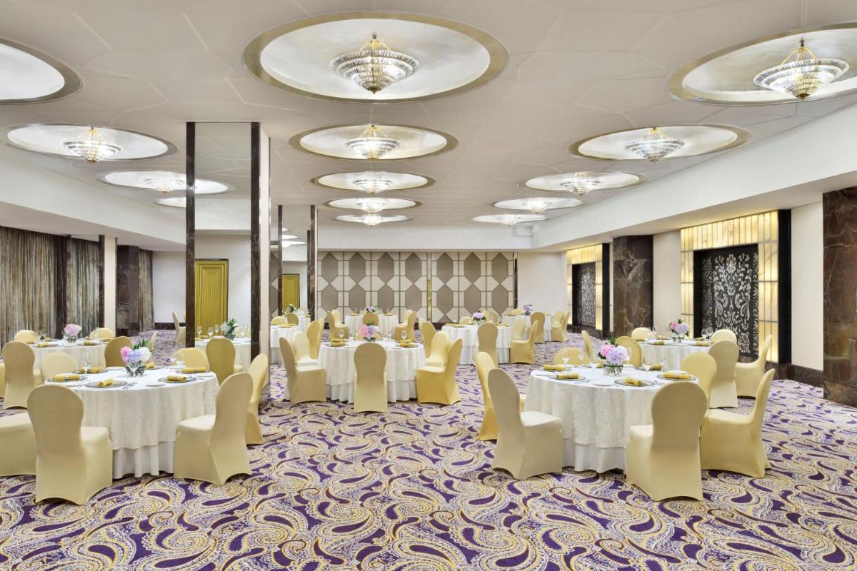 a banquet room with tables and chairs and chandeliers at The St. Regis Mumbai in Mumbai
