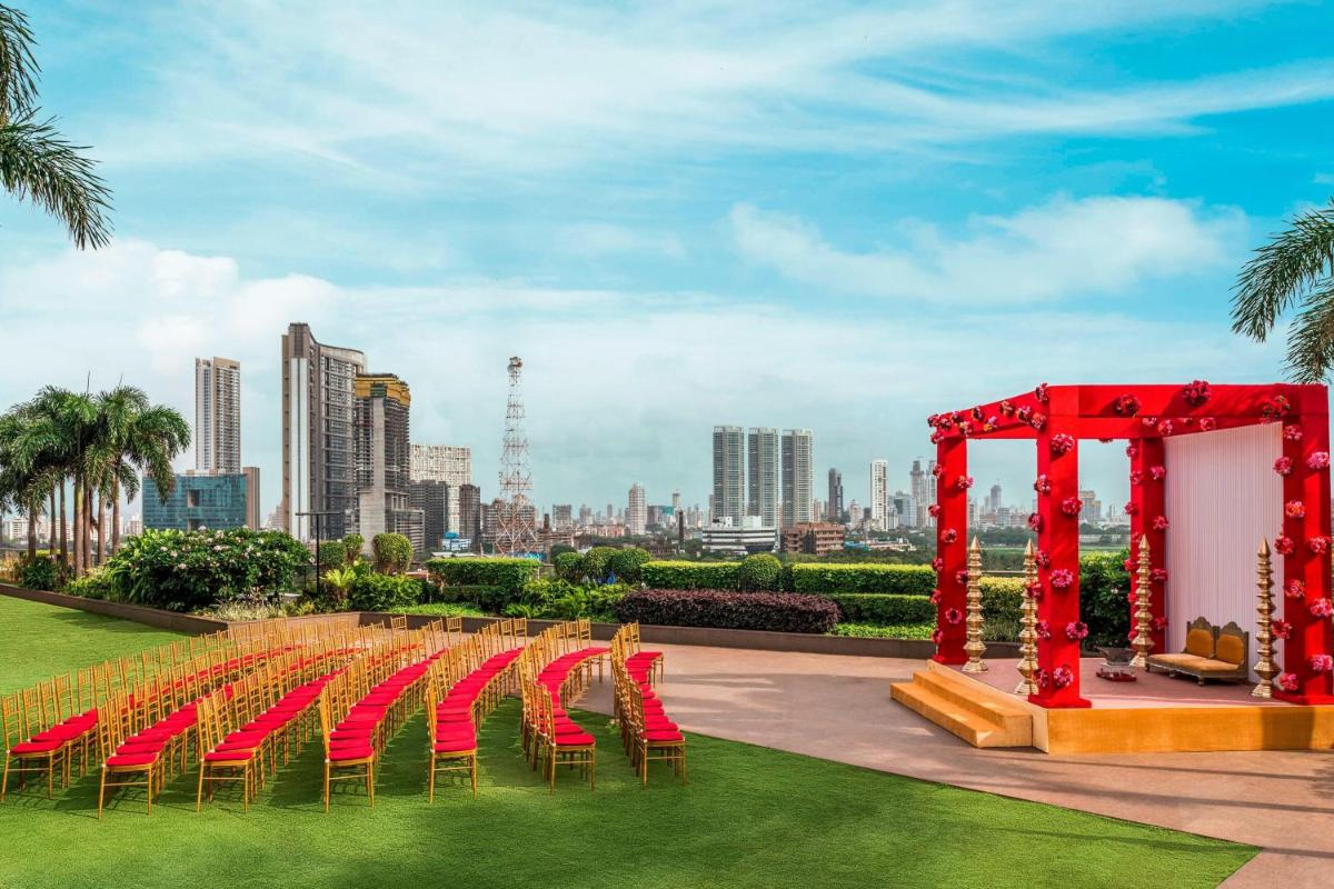 a set up for a wedding with a red arch and chairs at The St. Regis Mumbai in Mumbai