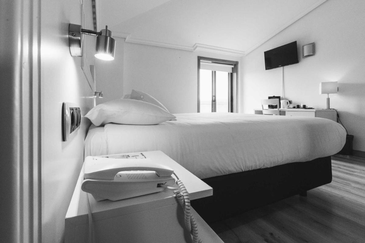 Cama o camas de una habitación en Hotel Alfonso I