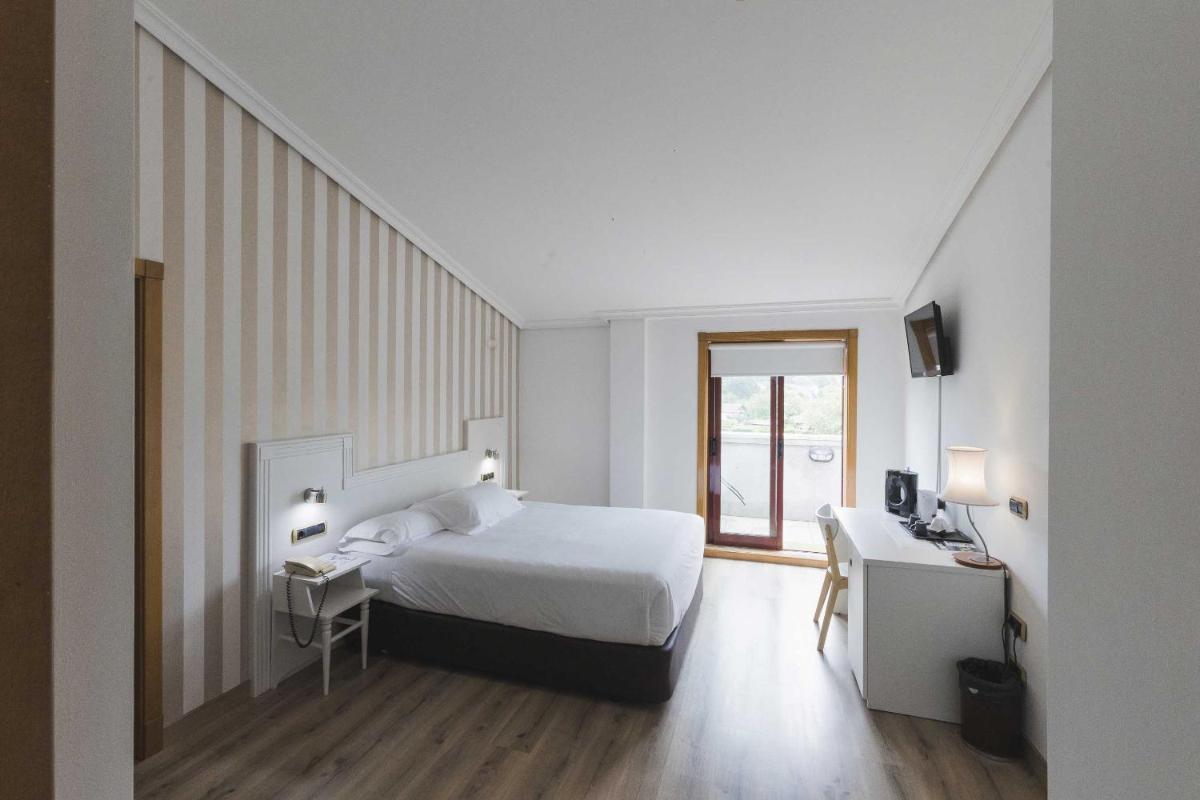 Cama o camas de una habitación en Hotel Alfonso I