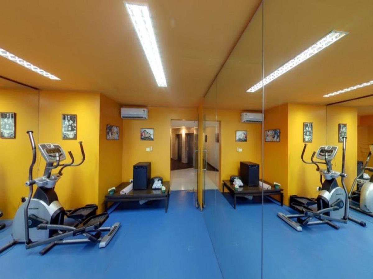 a gym with three treadmills and a mirror at Svenska Design Hotel, Electronic City, Bangalore in Bengaluru a gym with three treadmills and a mirror at Svenska Design Hotel, Electronic City, Bangalore in Bengaluru