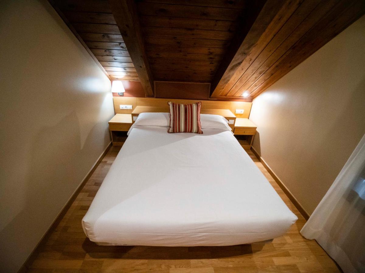 Cama o camas de una habitación en Aparthotel Siente Boí & SPA