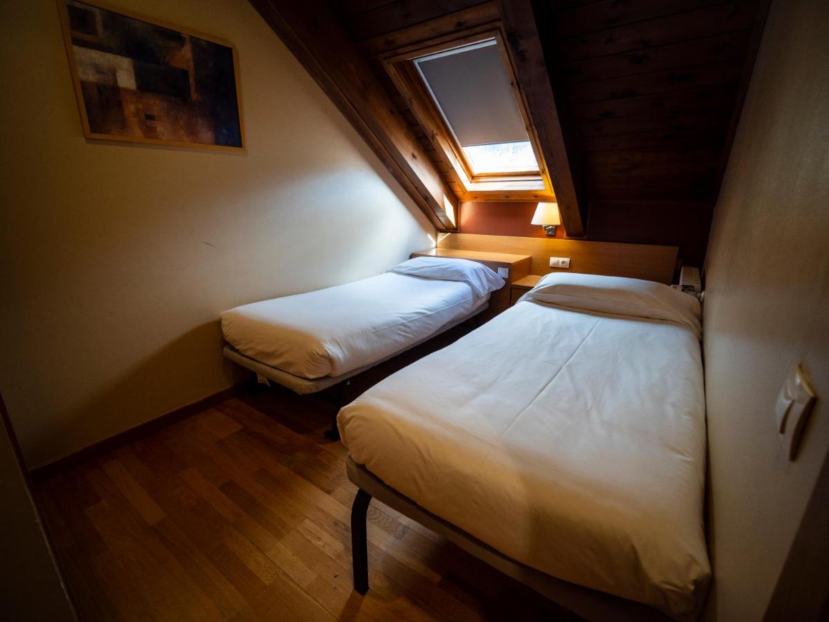 Cama o camas de una habitación en Aparthotel Siente Boí & SPA
