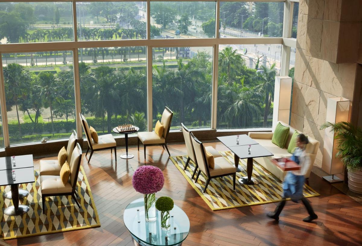 a young child walking through a lobby with a large window at Hyatt Regency Kolkata in Kolkata a young child walking through a lobby with a large window at Hyatt Regency Kolkata in Kolkata