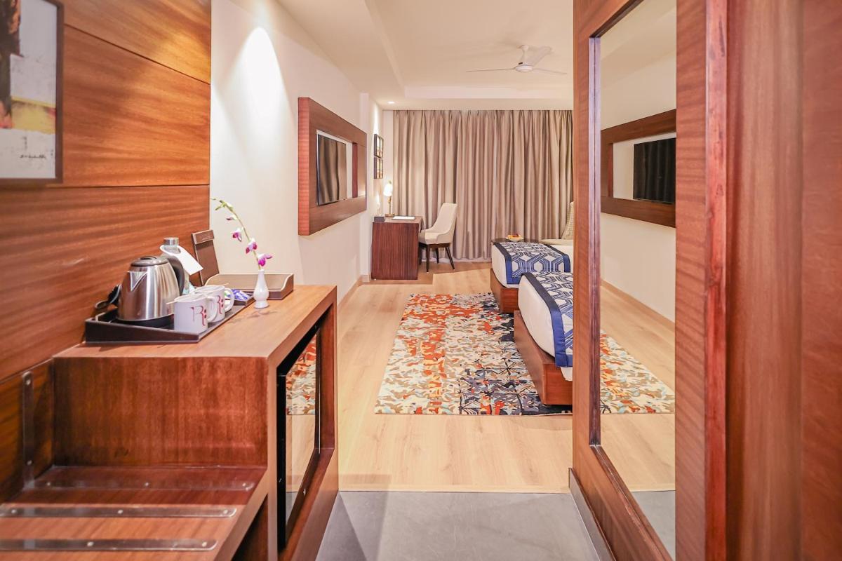 a hotel room with a room at Regenta Dehradun by Royal Orchid Hotels Limited in Dehradun