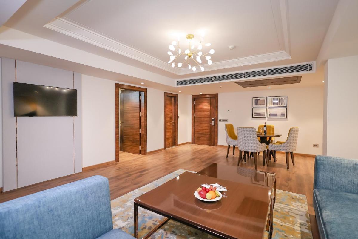 a living room with a couch and a table at Regenta Dehradun by Royal Orchid Hotels Limited in Dehradun