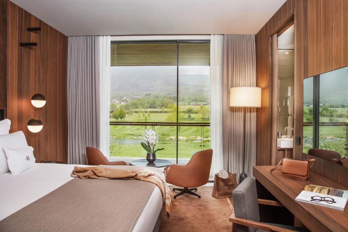 Un ou plusieurs lits dans un hébergement de l'établissement Jiva Hill Resort - Genève