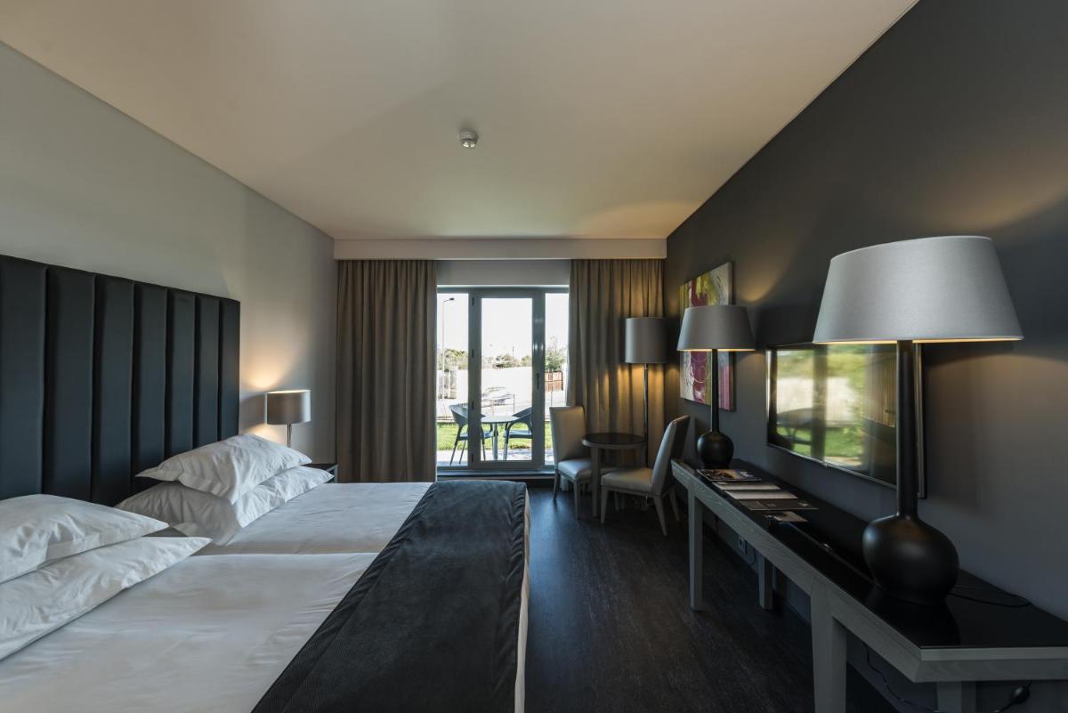 Uma cama ou camas num quarto em Vila Gale Evora
