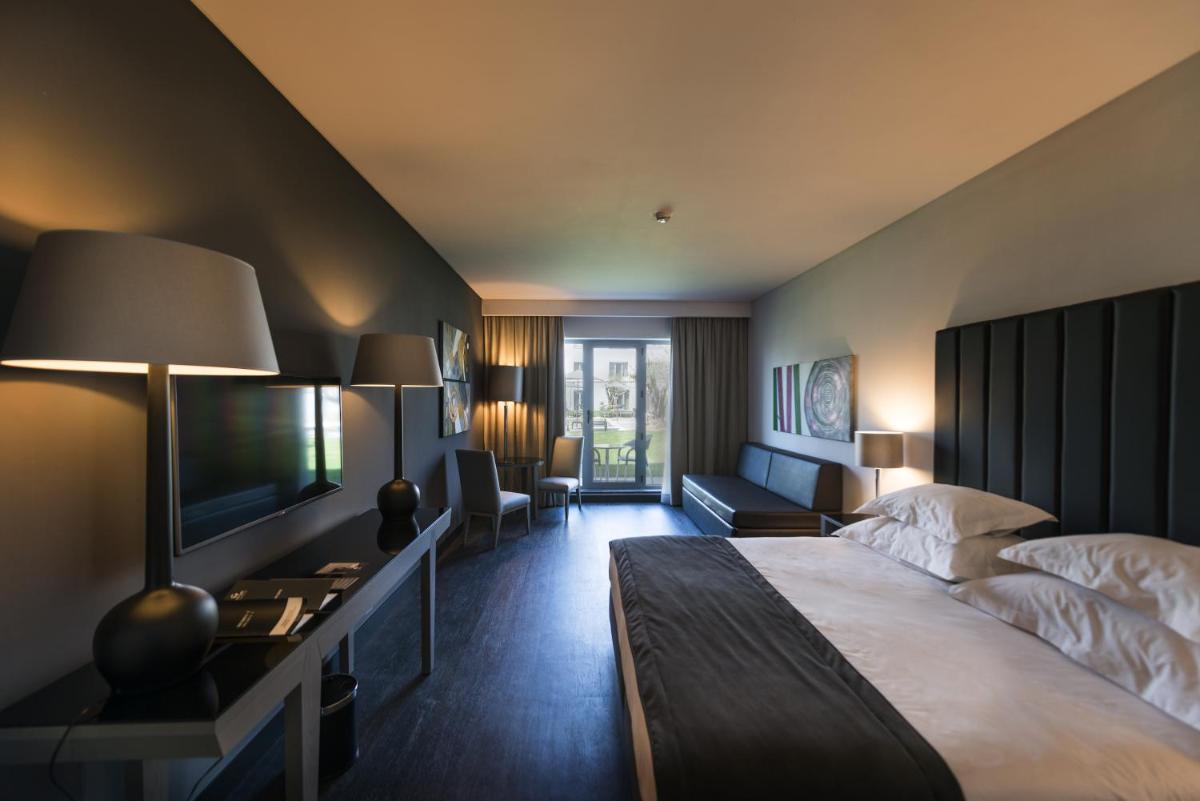 Uma cama ou camas num quarto em Vila Gale Evora