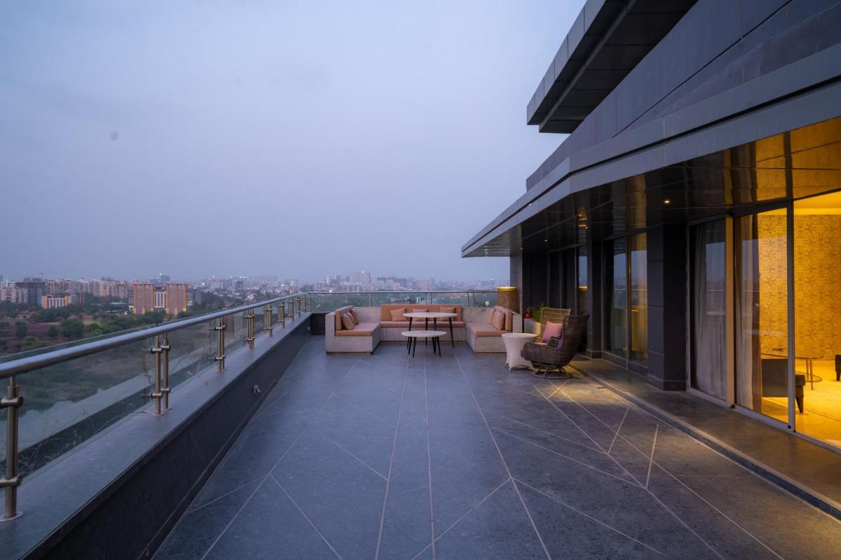 a balcony with chairs and a table on a building at The Westin Pune Koregaon Park in Pune