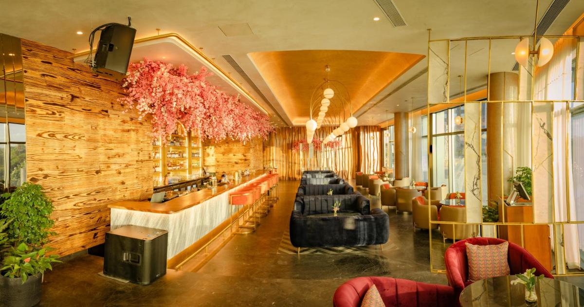 a restaurant with a row of tables and chairs at The Westin Pune Koregaon Park in Pune