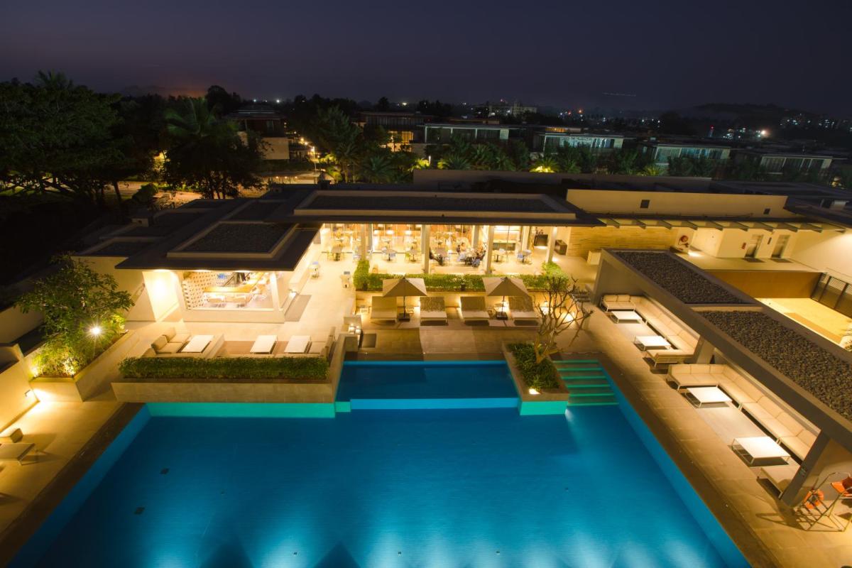 an aerial view of a villa with a swimming pool at night at BLVD Club - Near BENGALURU AIRPORT in Bengaluru an aerial view of a villa with a swimming pool at night at BLVD Club - Near BENGALURU AIRPORT in Bengaluru