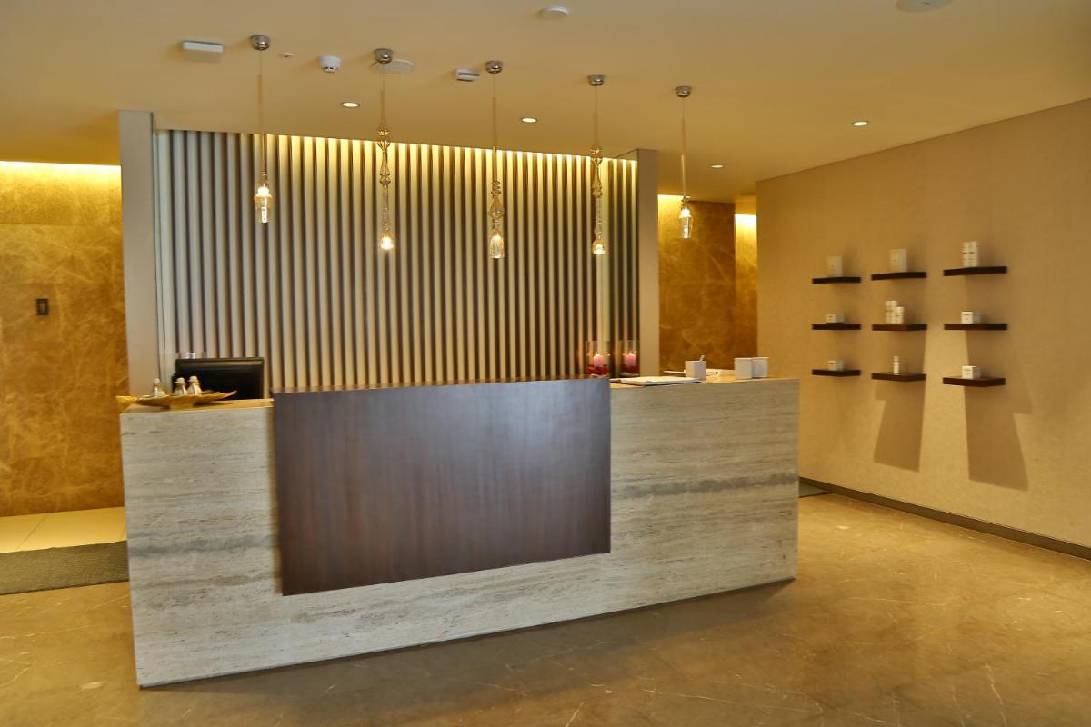 a lobby with a reception desk in a building at BLVD Club - Near BENGALURU AIRPORT in Bengaluru